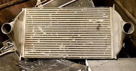 . Image of a metal radiator surrounded by scrap metal.